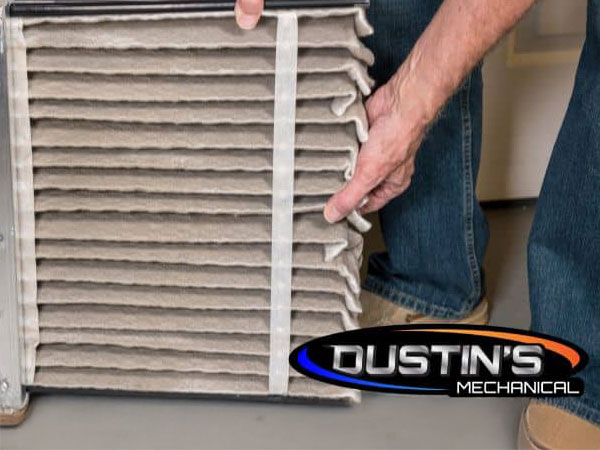 A person holding a rectangular air filter