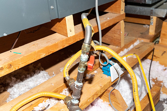 Gas line connection in an attic with yellow flexible piping